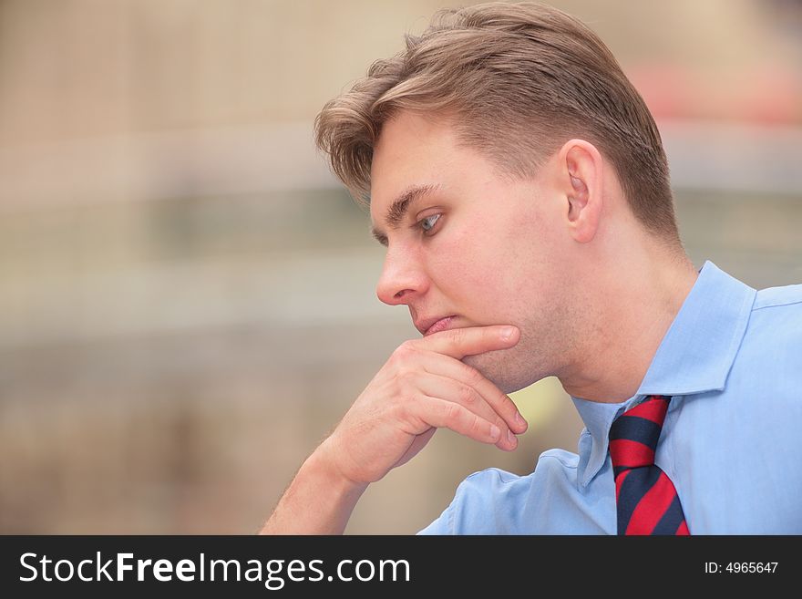 Portrait of young thinking businessman