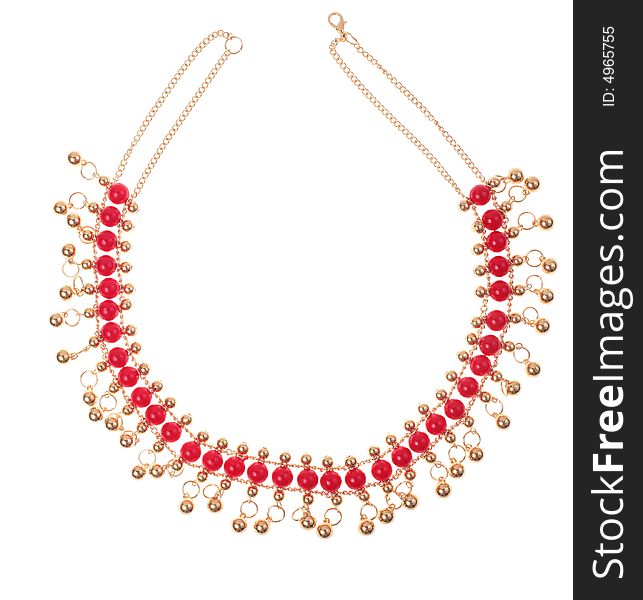 Golden necklace with red gems on a white