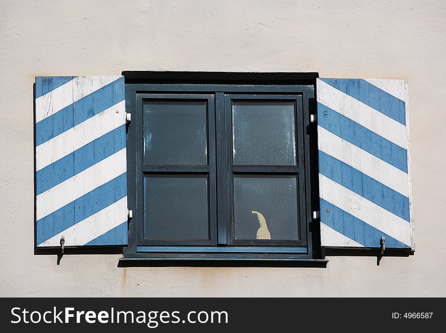 Window with shutters in bavarian colors