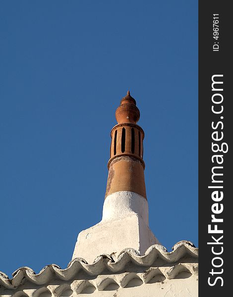 Local chimney from Algarve Portugal in a blue sky