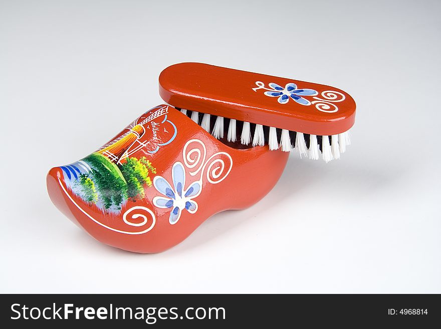 Red shoe brush isolated over light background