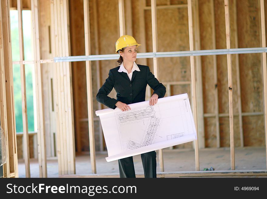 Young female architect at construction site