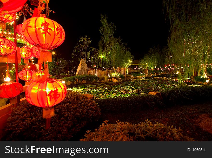 Red lanterns raised at prayer ceremony in temple grounds, taken at night. Red lanterns raised at prayer ceremony in temple grounds, taken at night