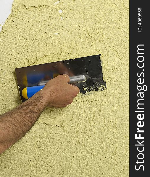 Constructor redecorating the house walls. Constructor redecorating the house walls