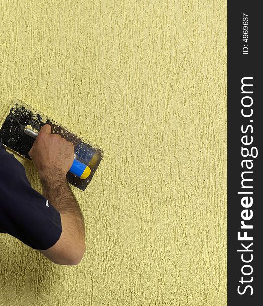 Constructor redecorating the house walls. Constructor redecorating the house walls