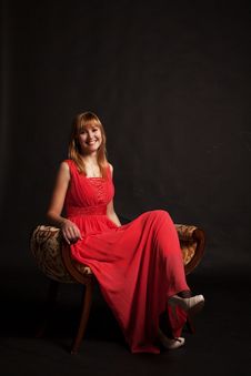 Young Beautiful Woman In Red Dress Sitting On A Chair Royalty Free Stock Photos Young Beautiful Woman In Red Dress Sitting On A Chair Royalty Free Stock Photos