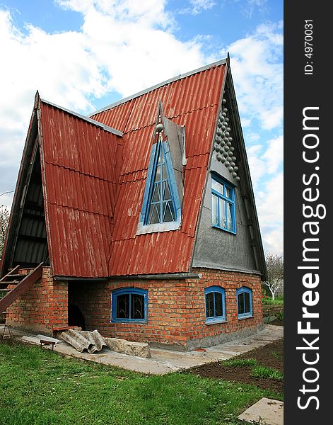 Small original country house and blue sky