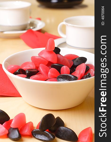 Candy with coffee cups in the background. Candy with coffee cups in the background