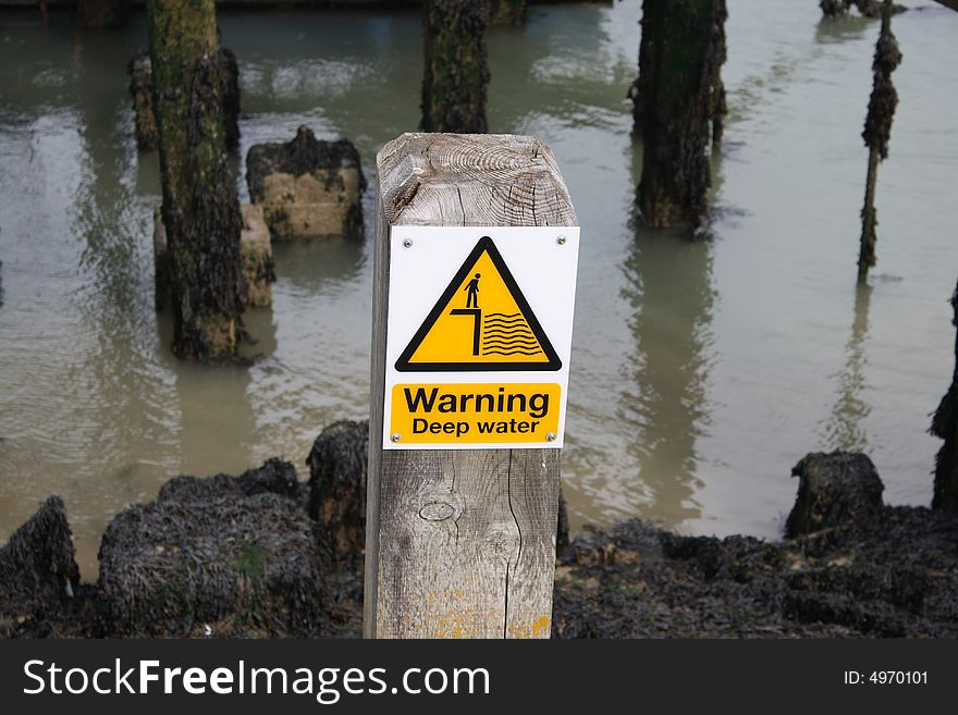 A deep water sign at the edge of the sea