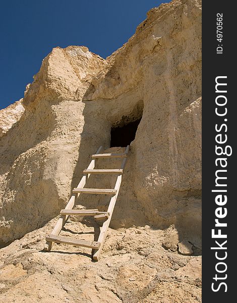 Wooden ladder ascending to cliff dwelling, Kazakhstan. Wooden ladder ascending to cliff dwelling, Kazakhstan