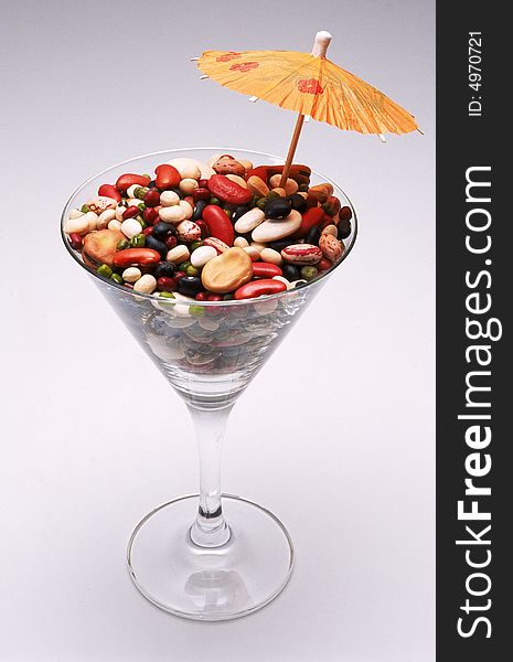 Mixed beans in cocktail glass with umbrella