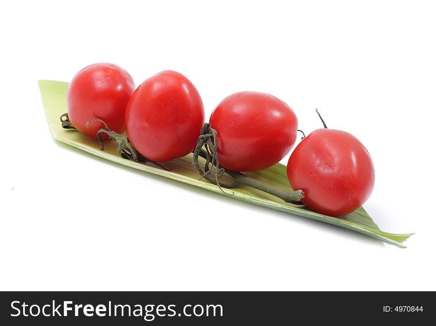 Vegetable still life of cherry tomato and salad. Isolated on a white background