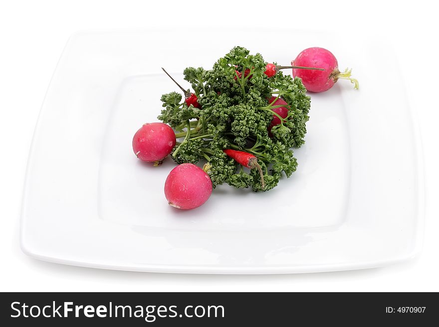 Vegetables on a plate. Isolated on a white background. Vegetables on a plate. Isolated on a white background