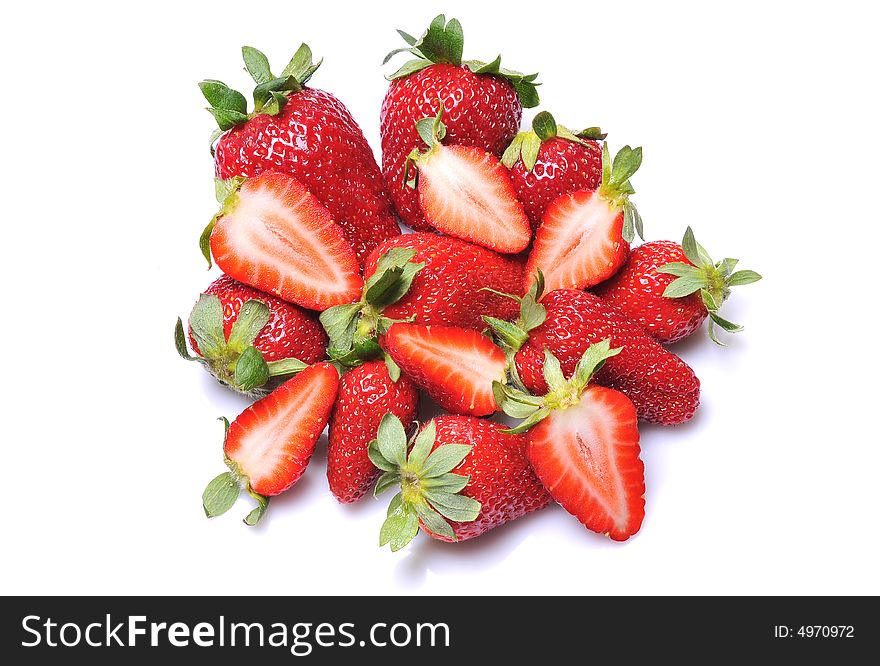 Close up of a group of fresh, succulent strawberries on white background