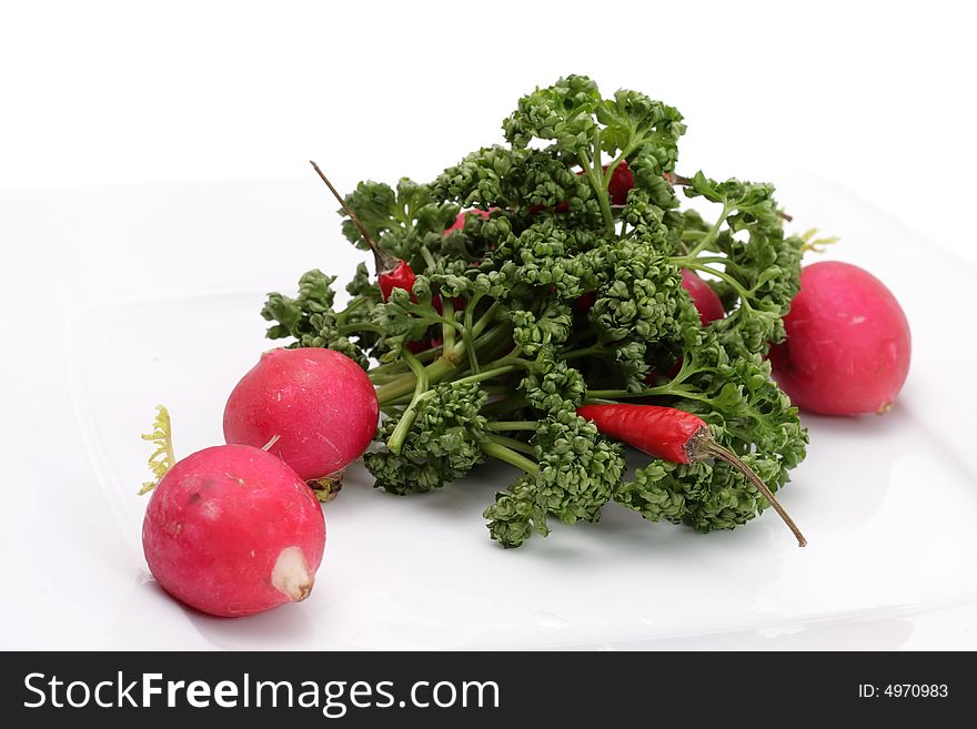 Vegetables on a plate. Isolated on a white background. Vegetables on a plate. Isolated on a white background