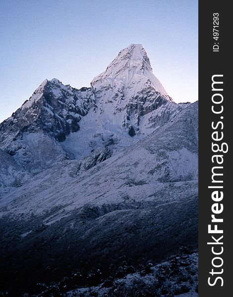 Ama Dablam in the sunrise light. The mount is often called the Matterhorn of the Himalayas. Ama Dablam means Mother and her Necklace and is a stunningly beautiful mountain in the Everest region of the Himalayas. Ama Dablam in the sunrise light. The mount is often called the Matterhorn of the Himalayas. Ama Dablam means Mother and her Necklace and is a stunningly beautiful mountain in the Everest region of the Himalayas.