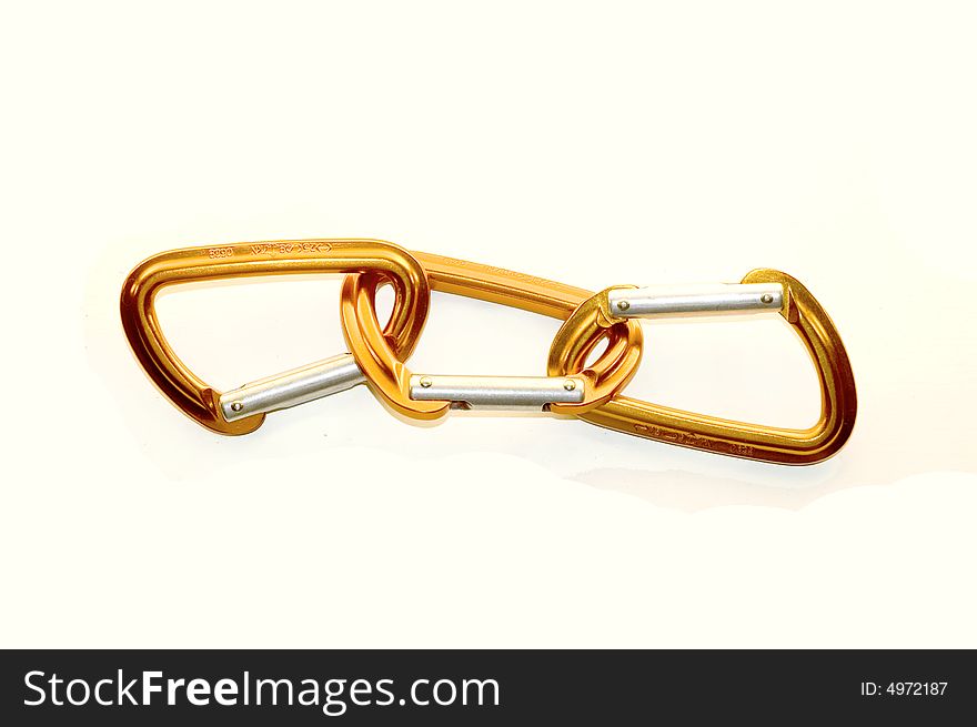 Three linked orange and silver karabiners/carabiners isolated on white background. Three linked orange and silver karabiners/carabiners isolated on white background