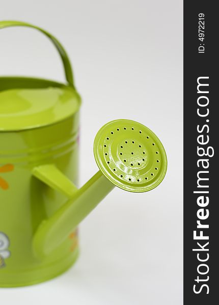 Isolated funny coloured watering can from close. Isolated funny coloured watering can from close