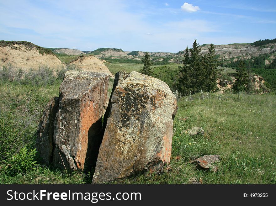 Unique split rock sitting in a badlands landscape