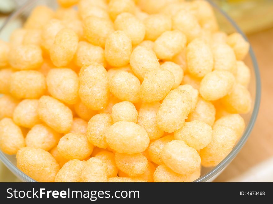 Yellow corn chips in a glass plate