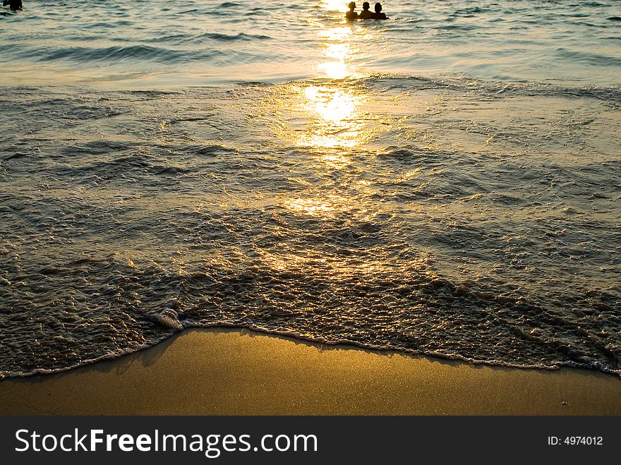 Sunset surf at the Patong beach, Phuket, Thailand