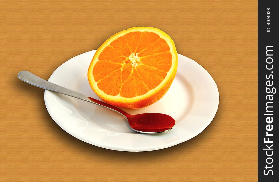 Orange on plate with spoon