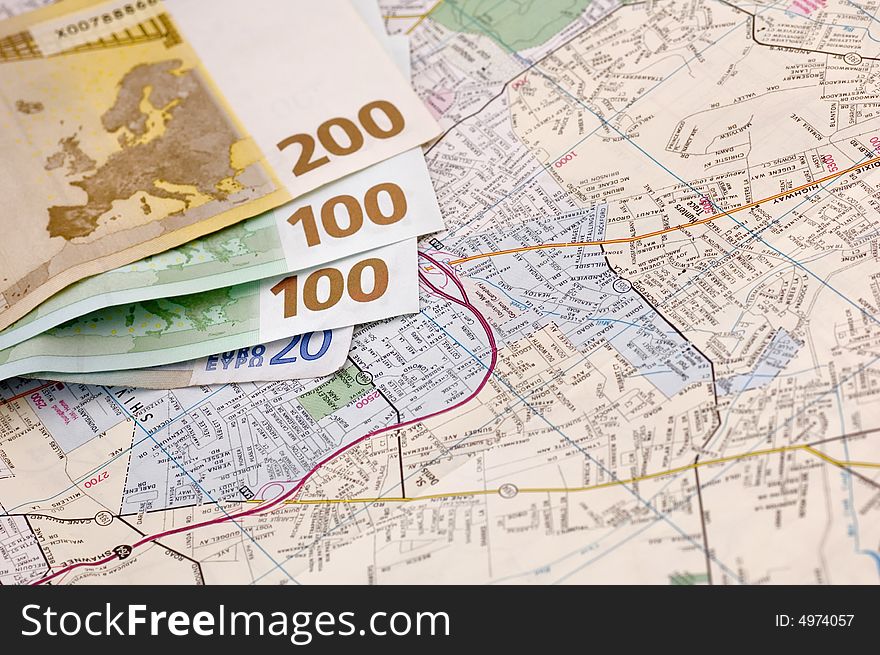 Banknotes of euros on the map