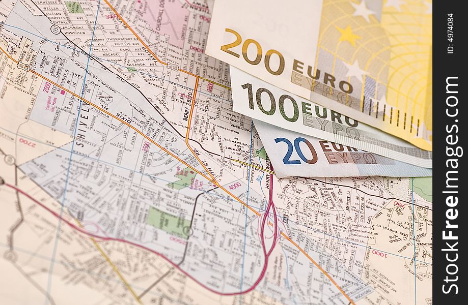 Banknotes of euros on the map