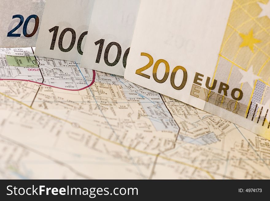 Banknotes of euros on the map