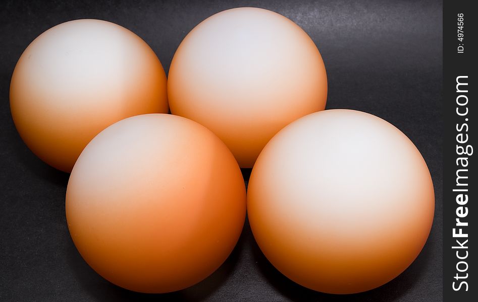 Abstract pattern of orange balls on black background