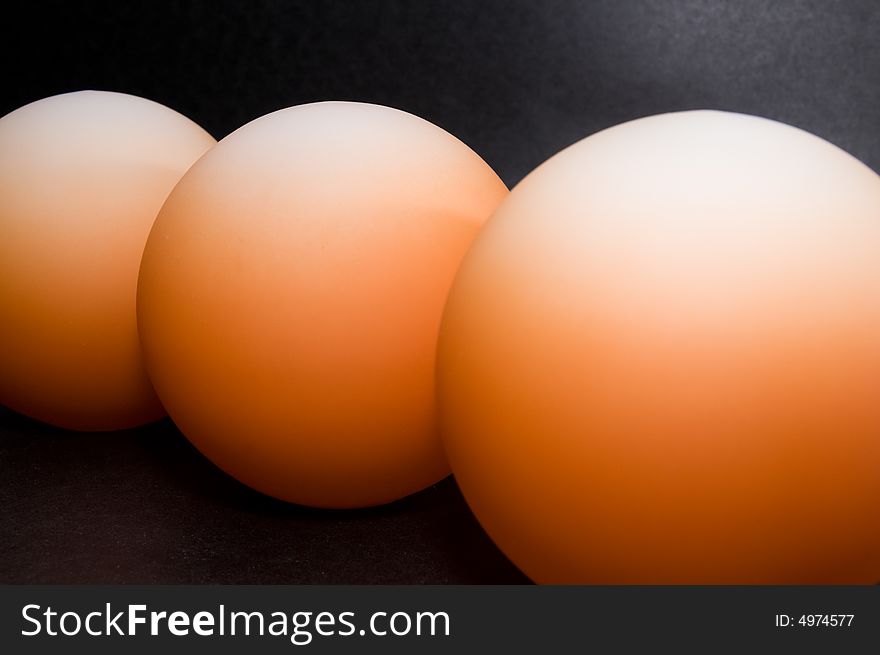 Abstract pattern of orange balls on black background