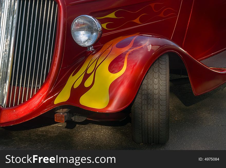 A classic bright red hotrod with flames. A classic bright red hotrod with flames