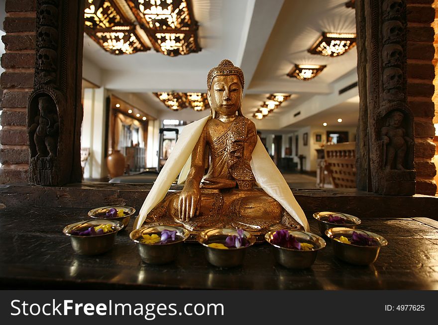 Buddha statue in front of mirror in hotel entrance