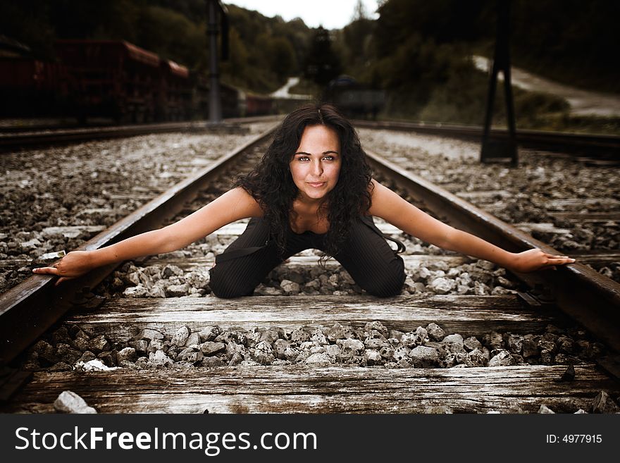 A girl kneeled on railway line. A girl kneeled on railway line