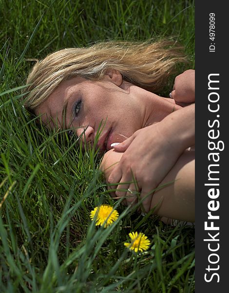 A girl laid on green grass