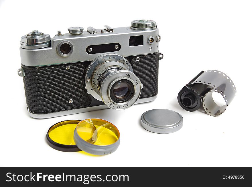 Vintage camera with photofilters and negativ film on white background.