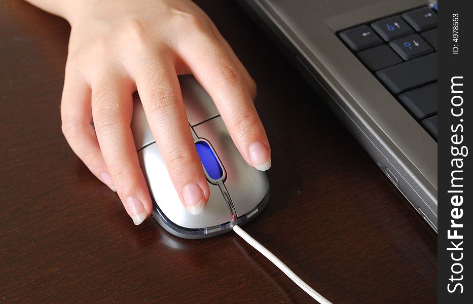 A lady hand using computer mouse. A lady hand using computer mouse