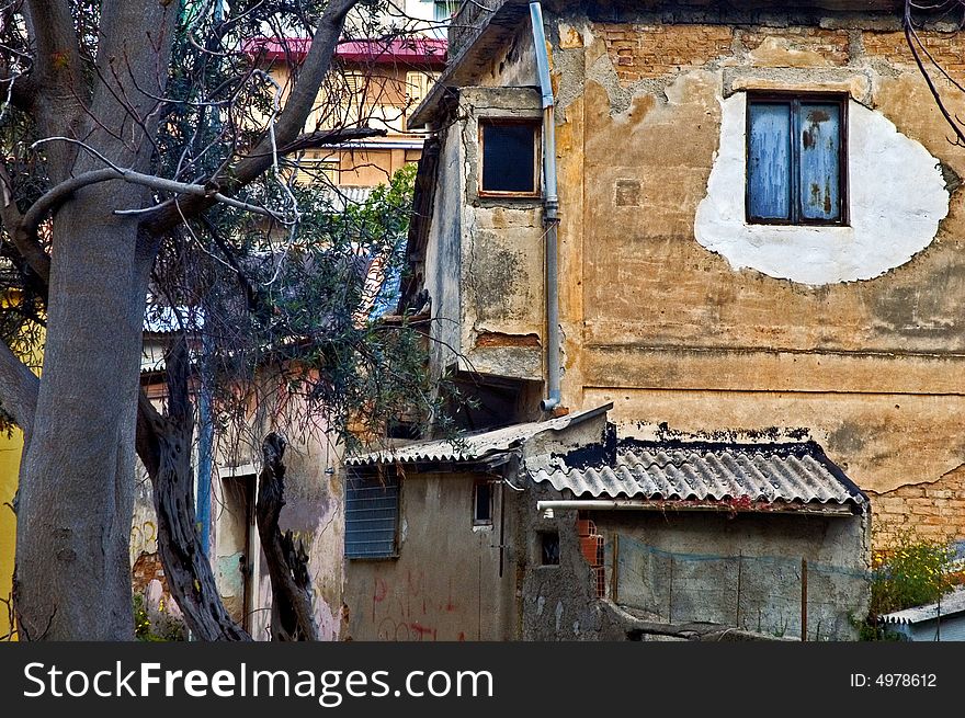 Decayed and spooky Italian house with barren tree. Decayed and spooky Italian house with barren tree