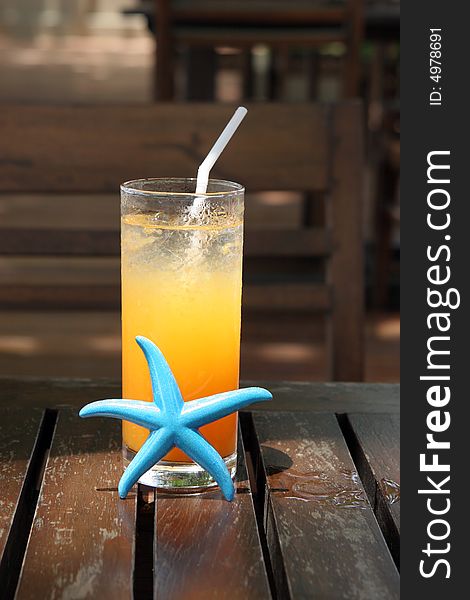 Glass of orange juice with a starfish.