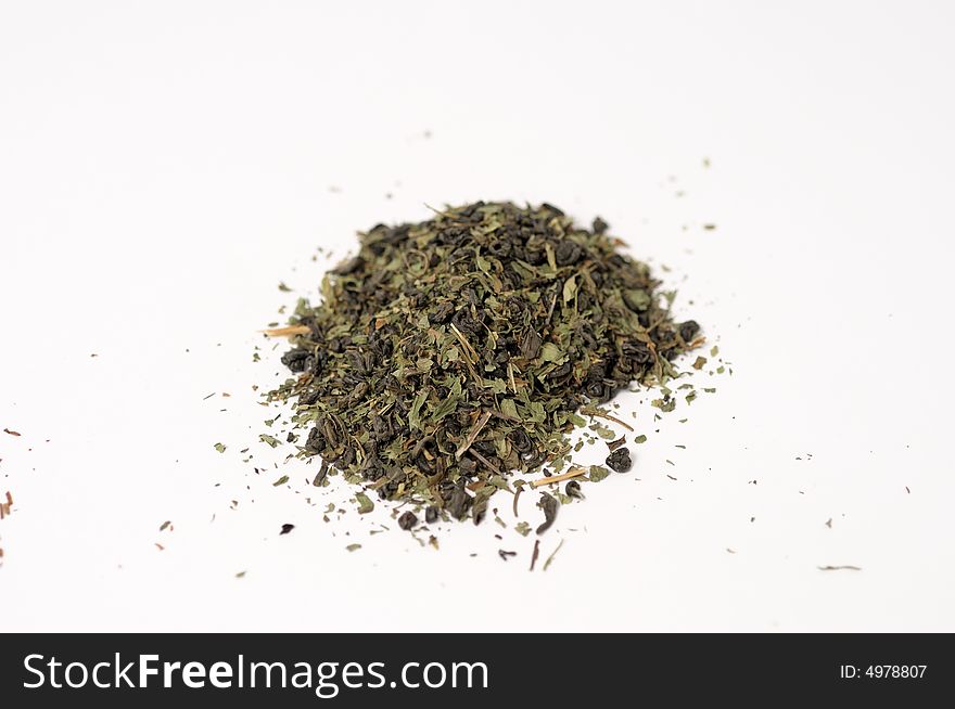 Green tea leaves on a white surface. Green tea leaves on a white surface