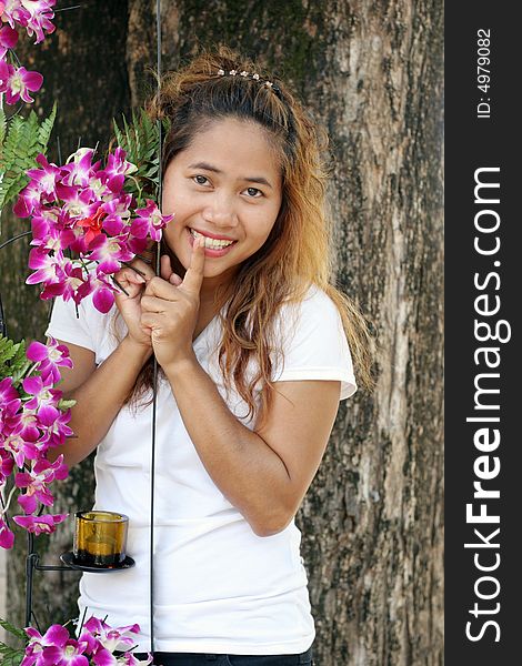 Portrait of a happy Thai woman with pink orchids. Portrait of a happy Thai woman with pink orchids.