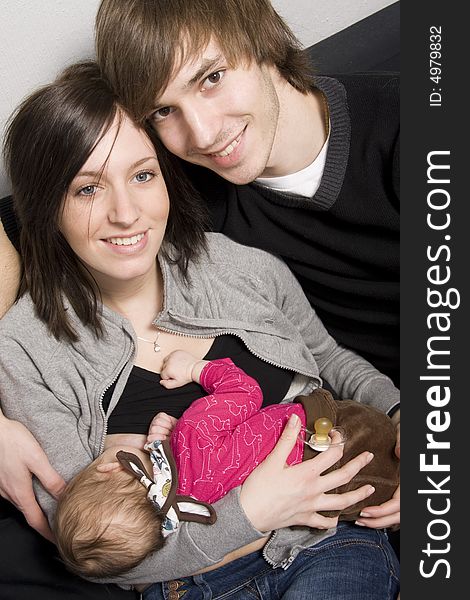 Happy young parents with their baby girl