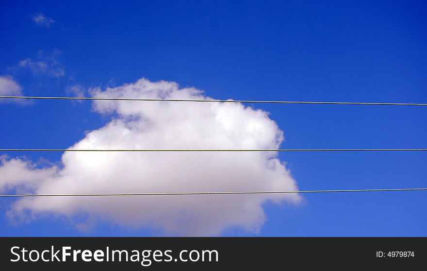 Telegraph wires against a beautiful blue sky with white cloud. Telegraph wires against a beautiful blue sky with white cloud