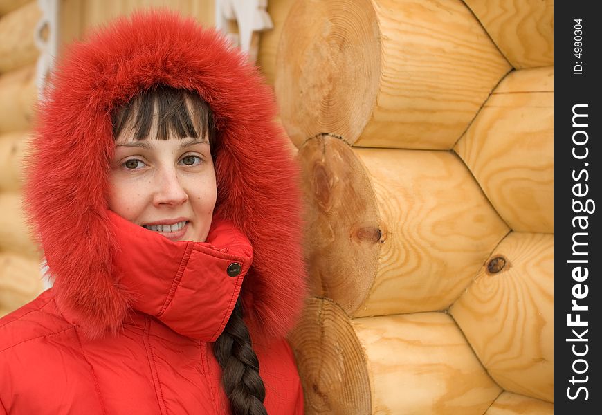 Cute Winter Girl and Wooden Wall on Background