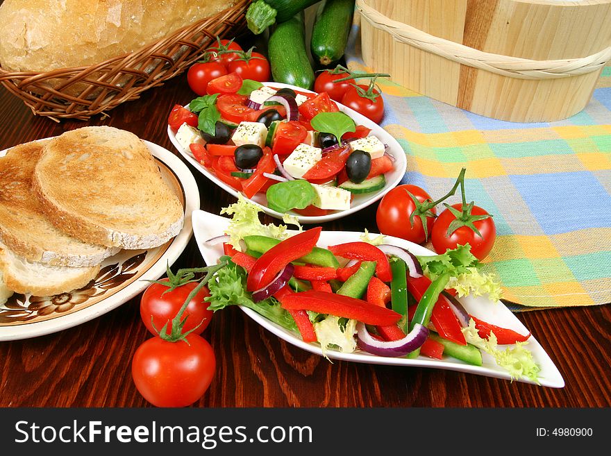 Greek salad with tomatos, mozzarella cheese, onions, olives