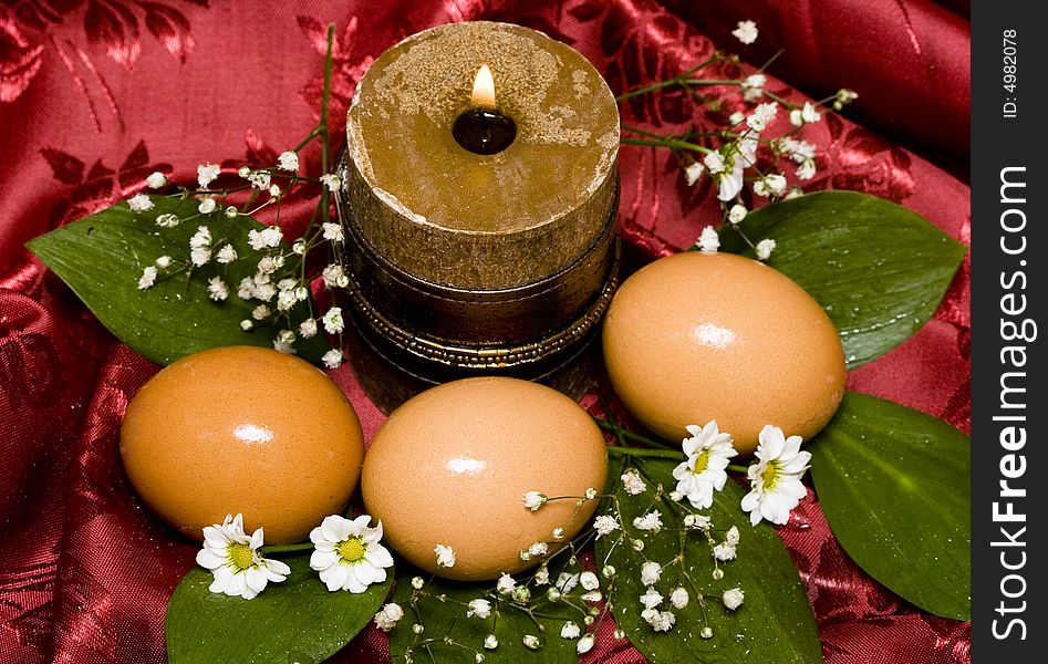 Easter eggs with white flowers and candle
