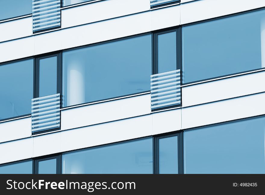 Building wall with blue windows.