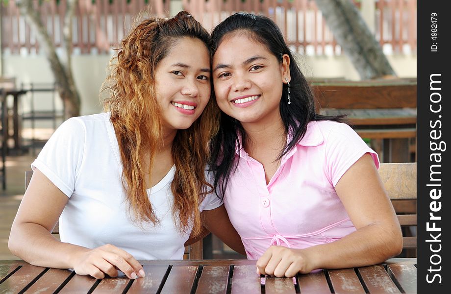 Portrait of two happy Asian friends.