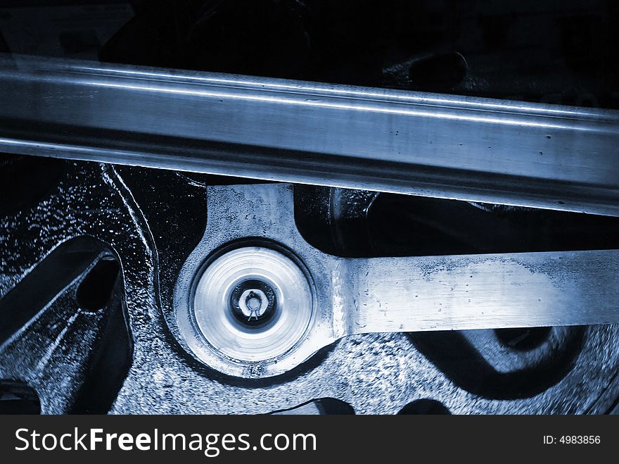 Close-up of railway engine wheels in blue