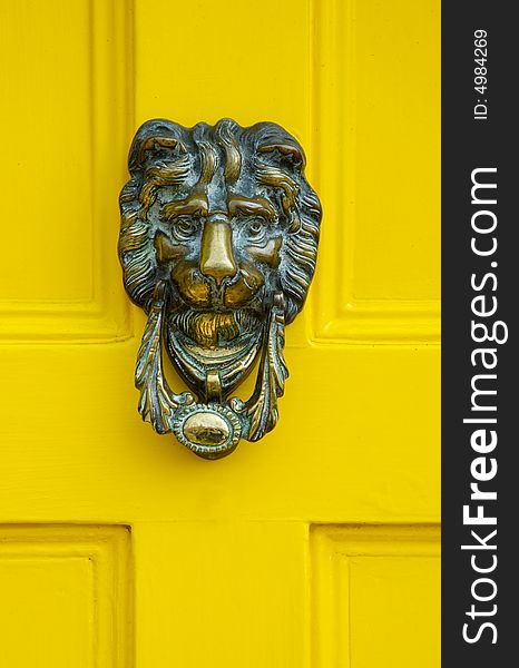 Traditional English Brass Door Knocker on a yellow door. Traditional English Brass Door Knocker on a yellow door